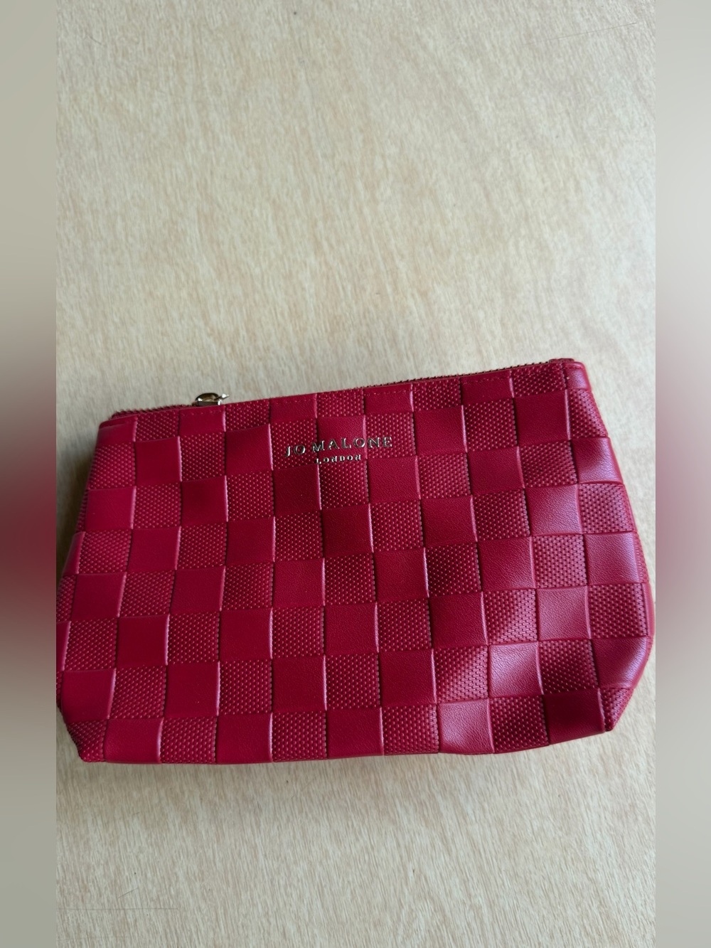 Jo Malone London cosmetic bag features a vibrant red woven design